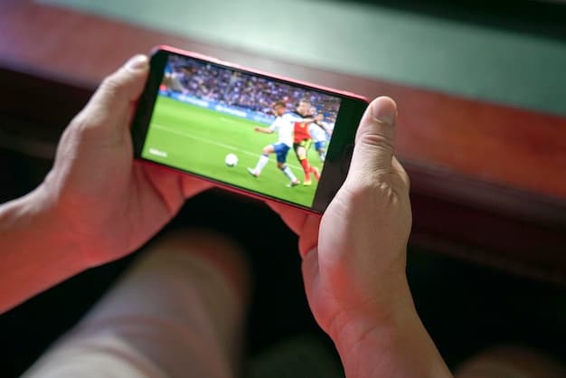 A close-up shot of a smartphone displaying a live Brazilian soccer game on a streaming app, with enthusiastic fans blurred in the background. The focus is on the crisp, high-definition quality of the stream.