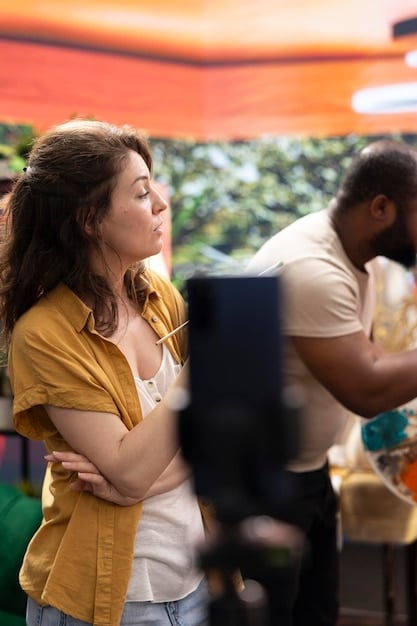 A still image from a Brazilian film available on a streaming platform, the scene depicting a tense moment between two characters in a dimly lit room. The streaming platform's interface frames the image.