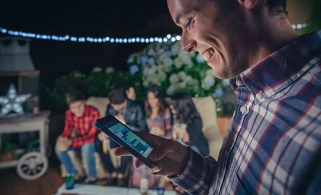 A person using their phone at a film festival, deliberately blurring the screen with their hand to avoid seeing spoilers. The surrounding environment is bustling with people and festival posters.