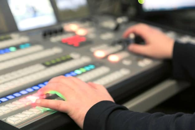A close-up shot of a sound engineer working at a mixing console in a recording studio, surrounded by various instruments and equipment. The lighting is dim and focused, highlighting the attention to detail in crafting a film soundtrack.