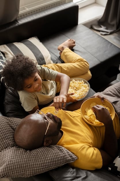 A Brazilian family happily watching a movie on a smart TV via a streaming service, with a bowl of popcorn and a cozy atmosphere.