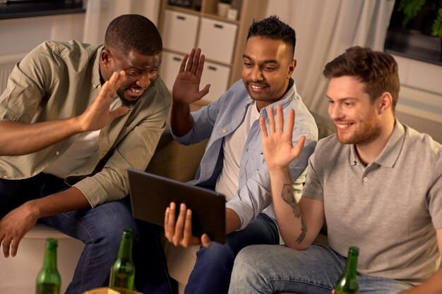 A group of diverse friends on a sofa, laughing and gesturing animatedly while discussing a show displayed on a tablet, symbolizing shared viewing experience and lively discussion.