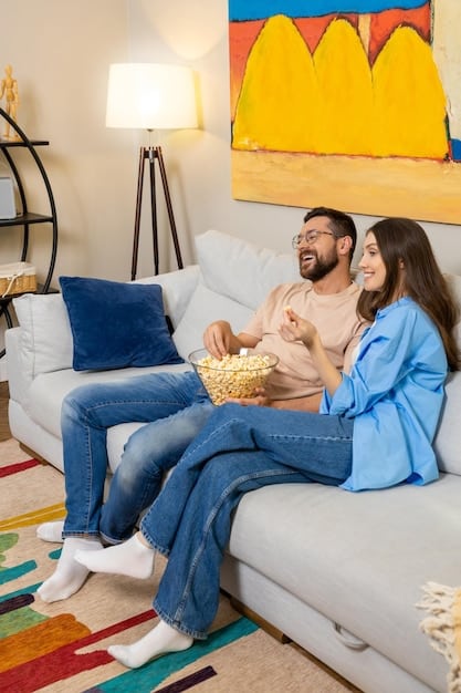 A family sitting on a couch, relaxed and watching a movie together, with the subtitles in Portuguese. The scene emphasizes togetherness and cozy home entertainment within Brazil.