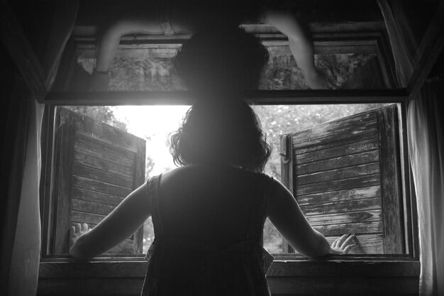 A woman's silhouette against a brightly lit window, holding a discarded newspaper with a headline about a missing person, suggesting contemplation and hidden motives. Her expression is unreadable.