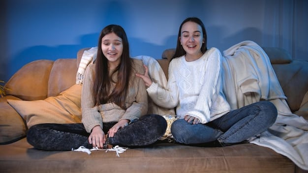 Friends sitting cross-legged on the floor, eyes glued to the TV screen during a tense scene in a movie. Some have their hands over their mouths in anticipation. Phones are placed neatly in a basket off to the side. The lighting is dim, creating an immersive viewing experience where no spoilers can ruin the atmosphere