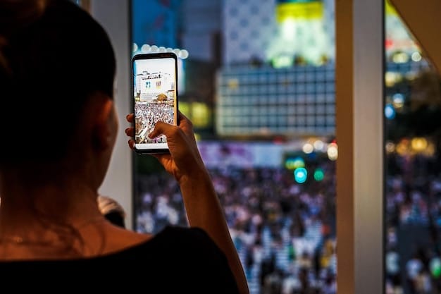 A person using a smartphone to browse movie news on social media. The screen displays a social media feed with blurred-out posts except for a clearly visible post marked with a 