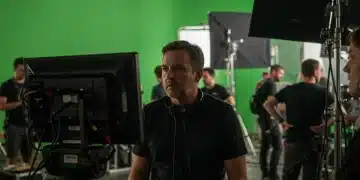 Director overseeing a complex scene on a Netflix set amidst crew and technical equipment, highlighting production challenges.